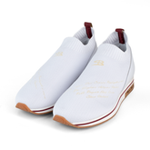 White slip-on shoes with brown soles on a white background